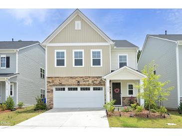 Charming two-story home featuring stone accents, a two-car garage, and a well-maintained front yard at 2264 Jollay St, Durham, NC 27703