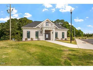 Attractive single story building with dark grey roof, light facade, and well manicured lawn at 23 Paper Birch Trl # 145, Garner, NC 27529