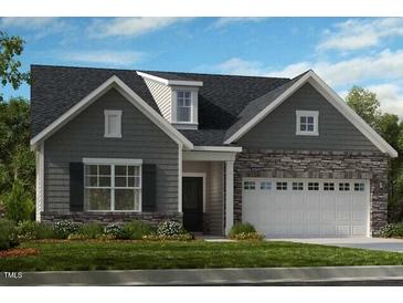 Charming gray home featuring stone accents, a two-car garage, and professionally landscaped yard at 237 Tidal Pool Way, Cary, NC 27519
