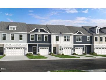 Row of new townhomes with a stone and siding facade, and individual one car garages at 2728 Sammish Way, Raleigh, NC 27616
