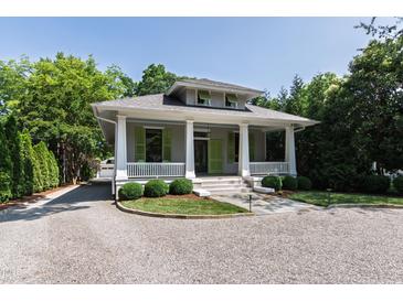Charming single-story home with green shutters, a large front porch, and manicured landscaping at 308 W Whitaker Mill Rd, Raleigh, NC 27608