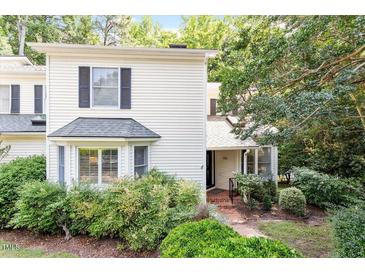 Charming home exterior with manicured landscaping, front porch, and neutral siding at 352 Weymouth Close, Pittsboro, NC 27312