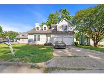 Charming two-story home featuring a two-car garage and a well-maintained front yard at 3712 Old Coach Rd, Raleigh, NC 27616