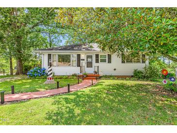 Charming single-story home featuring a brick walkway and well-maintained landscaping at 422 Hyde St, Burlington, NC 27217