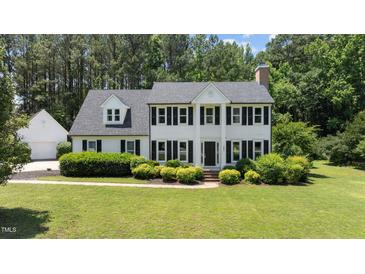 Charming two-story home with a landscaped lawn, dormer windows, and black shutters at 5301 Night Heron Dr, Wake Forest, NC 27587