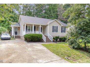 Charming home featuring a well-manicured front yard and a welcoming porch at 5817 Seward Dr, Knightdale, NC 27545