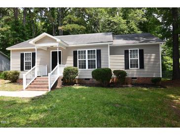 Charming single-story home with a welcoming porch and well-maintained landscaping at 5949 Sandy Run, Knightdale, NC 27545