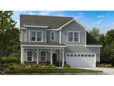Charming two-story home with a welcoming front porch and attached two-car garage at 680 Sun Meadow Dr, Wake Forest, NC 27587