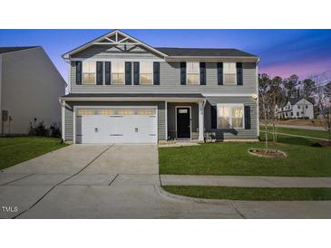 Charming two-story home with a well-manicured lawn and a two-car attached garage at 1004 Bridgewater Dr, Durham, NC 27704
