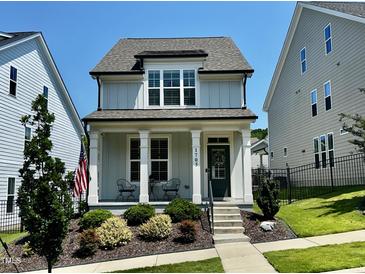 Charming two-story home with a cozy front porch, landscaped yard, and a delightful curb appeal at 1705 Main Divide Dr, Wake Forest, NC 27587