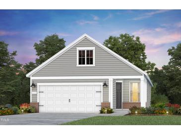 Charming one-story home featuring a two-car garage and gray horizontal siding at 1816 Gazania Dr, Fuquay Varina, NC 27526