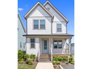 Charming two-story home with welcoming front porch and well-maintained landscaping at 212 Aubey Ln, Wake Forest, NC 27587