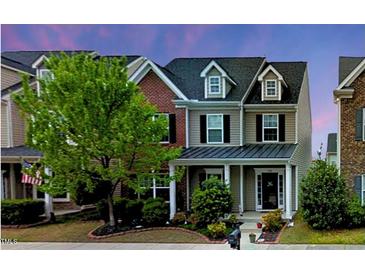 Charming townhouse with a landscaped front yard and inviting entryway, perfect for a cozy Gathering home at 732 Keystone Park Dr, Morrisville, NC 27560