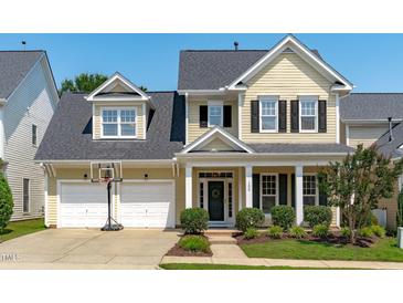 Charming two-story home featuring a two-car garage, well-manicured lawn and covered porch with white pillars at 105 Bridgegate Dr, Cary, NC 27519