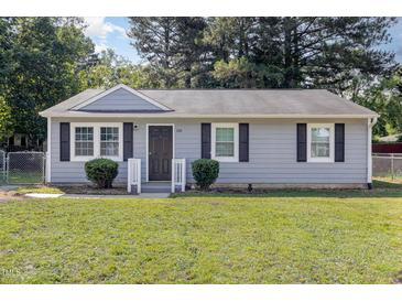 Charming single-story home with gray siding, black shutters, and a well-manicured lawn at 1110 Allgood St, Durham, NC 27704