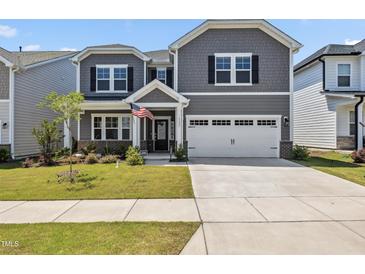 Charming two-story home with gray siding, white trim, and an attached two-car garage at 1177 Sun Springs Rd, Wake Forest, NC 27587