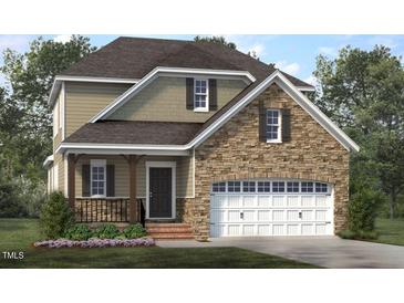 Charming two-story home featuring a stone facade, attached garage, and inviting covered porch at 172 White Magnolia Ln, Fuquay Varina, NC 27526