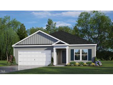Charming one-story home featuring a gray exterior, a two-car garage, and a well-manicured front yard at 228 Palomino Way, Clayton, NC 27520
