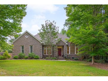 Charming brick home featuring a well-manicured lawn and mature trees at 2312 Shallowford Ln, Chapel Hill, NC 27517