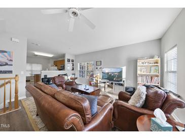 Comfortable living room features leather furniture, a ceiling fan, and lots of natural light at 2910 Barrymore St # 100, Raleigh, NC 27603