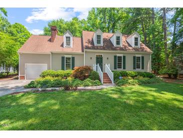 Charming single-Gathering home with lush green lawn, mature landscaping, and dormer windows at 3806 Lochnora Pkwy, Durham, NC 27705