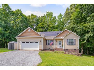 Charming single-story home with neutral siding, stone accents, and an attached two-car garage at 62 Mountain Laurel Ln, Four Oaks, NC 27524
