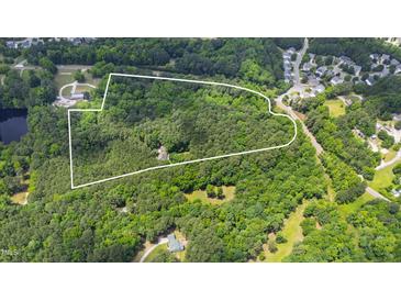 Aerial view of heavily wooded lot outlined in white with limited clearing for house at 7104 Camp Branch Ln, Apex, NC 27502