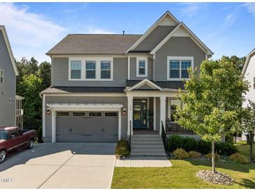 Charming two-story home showcasing neutral siding, an attached garage, and a welcoming front porch at 98 Stone Bridge Xing # 98, Chapel Hill, NC 27517