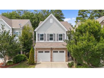 Charming home featuring stone accents, a two-car garage, and beautiful landscaping at 2057 Tanners Mill Dr, Durham, NC 27703
