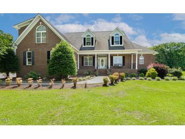 Charming two-story brick home with a manicured lawn and inviting front porch at 206 W Stoneybrook Ct, Benson, NC 27504