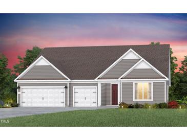 Charming single-Gathering home with a three-car garage, beautiful lawn, and inviting front entrance at 2516 Del Webb Gardens Dr, Fuquay Varina, NC 27526