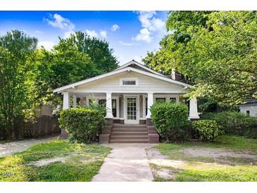 Charming home featuring a welcoming front porch, classic architectural details, and a well-maintained lawn at 306 Union Ave, Burlington, NC 27217