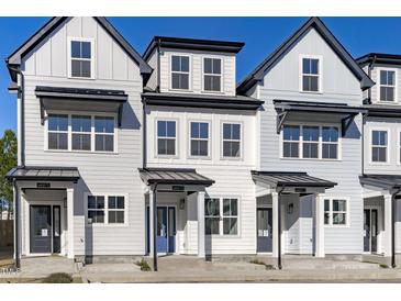 Charming new construction townhomes showcasing unique architectural detail, curb appeal, and inviting front entrances at 4821 Gossamer Ln # 102, Raleigh, NC 27616