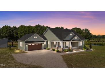 Charming home featuring a covered porch and well-manicured landscaping at 540 Pine Ridge Rd, Zebulon, NC 27597