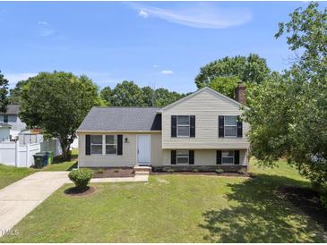 Charming split-level home featuring a well-maintained lawn and classic black shutters at 5529 Wood Pond Ct, Raleigh, NC 27610