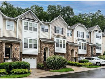 Attractive townhome exteriors featuring stone accents, neutral siding, garage, and tidy landscaping at 6206 Braidwood Court Ct, Raleigh, NC 27612