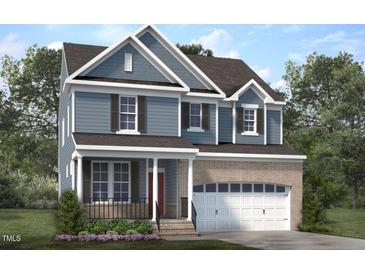 Charming two-story home boasts a brick-accented garage and inviting front porch at Lot 53 Magnolia Acres Ln, Fuquay Varina, NC 27526