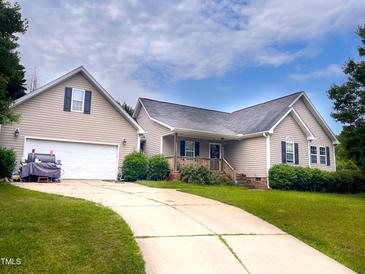 Charming home featuring a two-car garage, well-manicured lawn, and inviting curb appeal at 101 Langston Ridge Dr, Angier, NC 27501