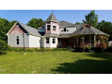 Unique home with a turret, covered porch, and multiple roof lines at 2816 Shepard School Rd, Zebulon, NC 27597