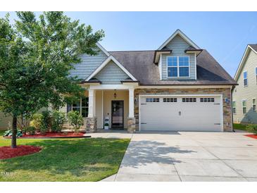 Charming home with a two-car garage, stone accents, and a well-manicured lawn at 29 Laurel Ln, Youngsville, NC 27596