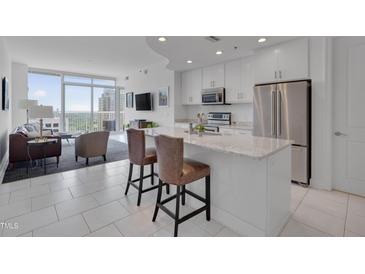Modern kitchen with white cabinets, stainless appliances and granite counters at 301 Fayetteville St # 2611, Raleigh, NC 27601