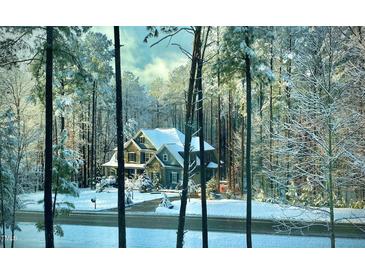 Charming home exterior featuring stone accents and a snowy landscape at 3587 Garner Terrace Way, Wake Forest, NC 27587