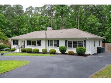 Charming one-story home with a well-manicured front lawn and a paved driveway at 3934 Hope Valley Rd, Durham, NC 27707