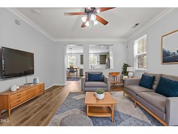 Inviting living room with an open concept layout, seamlessly connected to the kitchen and dining area at 1104 Pebblestone Drive, Durham, NC 27703