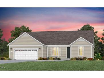 Charming single-story home with a two-car garage, neutral siding, and a well-manicured lawn at 123 Arcadius Dr, Clayton, NC 27520