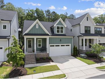 Charming two-story home featuring a neatly manicured lawn and an attached two-car garage at 167 Monteith Dr, Chapel Hill, NC 27516