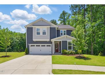 Charming two-story home features a well-manicured lawn and an attached two-car garage at 187 Harpers Landing Rd, Garner, NC 27529