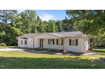 Charming single story home boasts a large front yard, covered porch, and classic curb appeal in a tranquil setting at 282 Cooke Rd, Louisburg, NC 27549