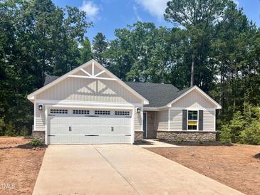 Charming single-story home with a two-car garage and a welcoming facade at 311 Rothbury Ct, Sanford, NC 27330