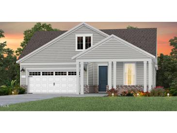 Charming two-story home featuring an attached garage and a covered front porch framed by elegant columns at 323 Arcadius Dr, Clayton, NC 27520